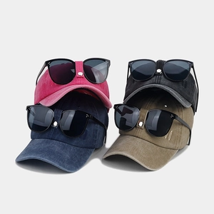 Detail view of vintage pilot baseball caps in four colors with integrated sunglasses