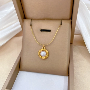 Titanium steel gold necklace with round pearl pendant in a beige jewelry gift box