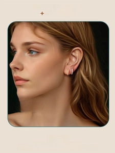 Close-up of elegant moissanite hoop earrings in gold and silver finish on female model