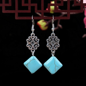 Vintage ethnic earrings with turquoise diamond-shaped pendants and hollow silver carvings