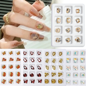 Detailed view of assorted 12-slot nail art crystal sets in champagne and red autumn colors