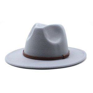 Close-up of grey wool fedora hat featuring a brown leather decorative embossed band
