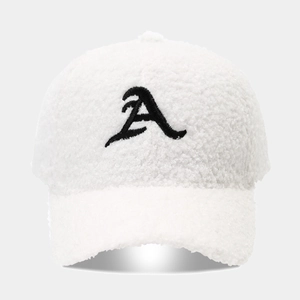 Close-up of white plush baseball cap featuring a black embroidered letter A detail
