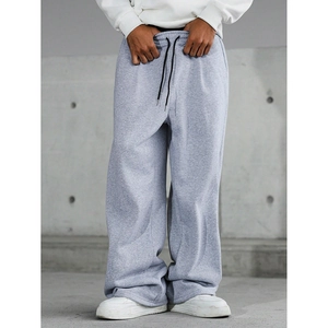 Detailed close-up of men's grey jogger pants showing drawstring waist and knit texture