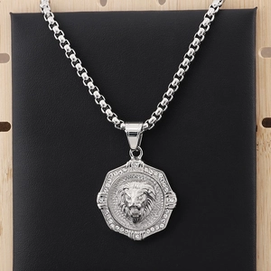 Detail of silver lion head pendant with sparkling rhinestones and octagon frame