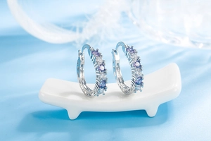 Close-up of S925 sterling silver hoop earrings with gradient purple and blue stones