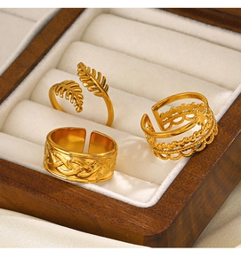 Detailed macro of gold leaf ring and celtic band in luxury wooden jewelry box