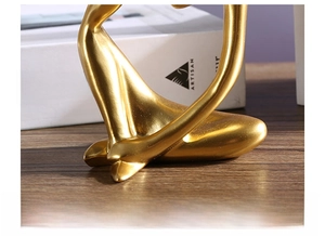 Detailed macro view of the stable base and golden resin surface of this abstract sculpture