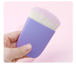 Detailed view of dense white bristles on a purple matte handle flat blush brush