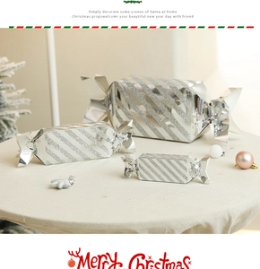 Three-tier set of silver striped candy-shaped Christmas gift boxes in festive interior