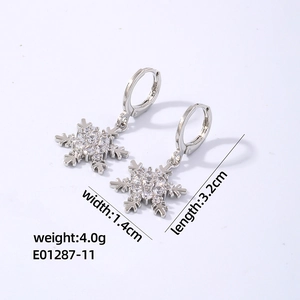 Detail view of silver snowflake earrings with sparkling zircons, 1.4cm by 3.2cm size