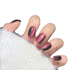 Short round cat eye press-on nails with black and magenta gradient glitter finish