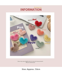 Detailed view of colorful plush heart hair clips in soft candy colors on a desk
