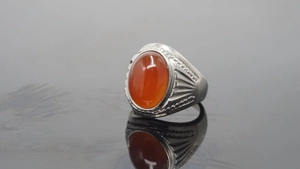 Macro shot of vintage titanium steel ring with large oval red carnelian gemstone inlay