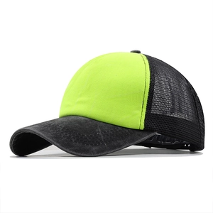 Detailed side view of a distressed washed denim trucker hat with neon yellow front panel