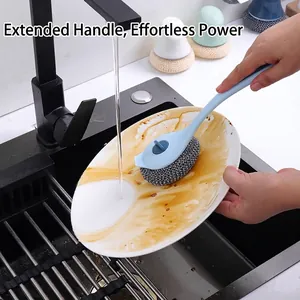 Long handle kitchen dish brush scrubbing a greasy plate under running water