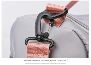 Detail of pink detachable shoulder strap with swivel hook on grey fitness bag