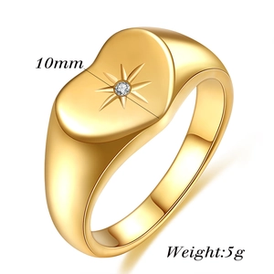 Detailed view of 10mm gold signet ring with starburst engraving and small zircon