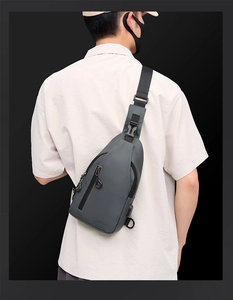 Detail view of adjustable nylon strap and waterproof texture on dark grey chest bag