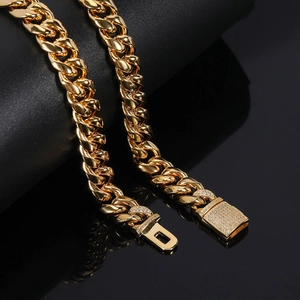 12mm gold stainless steel Cuban chain necklace with zircon encrusted buckle on black background