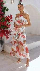 Detail of multi-layered ruffle hem with vibrant floral prints on white chiffon dress