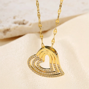 Macro shot of layered heart pendant with sparkling pavé zircons in gold plating