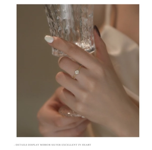 Detail of s925 silver flower ring with micro-set zircon on twisted rope band