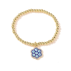 Detailed shot of 18K gold plated beaded bracelet with blue evil eye flower charm