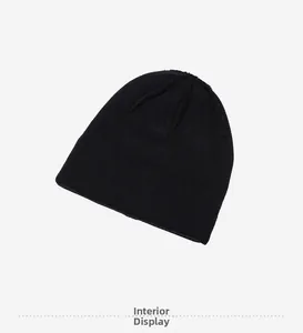 Detail view of the soft interior lining and stitching of the black winter beanie hat