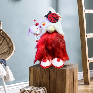 Close-up of a ladybug-themed Christmas gnome plush with red spotted ribbons and white beard