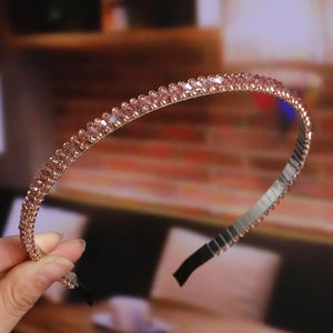 Detailed close-up of handmade beaded headband with champagne crystals on a gold wire