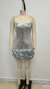 Detail of silver sequin mini dress featuring 3D rose ruffles and metallic finish fabric