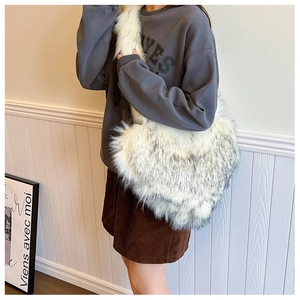 Furry heart-shaped shoulder bag in white and grey gradient faux fox fur on model