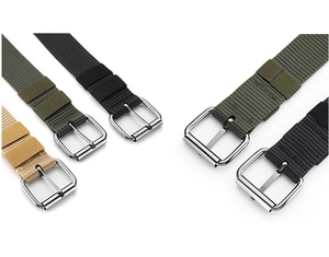 Flat lay of nylon woven belts in khaki, army green, and black with metal pin buckles