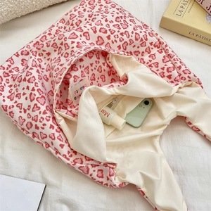 Interior detail of pink heart leopard canvas tote with lining and inner zip pocket