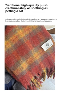 Close-up of red and yellow plaid faux cashmere scarf with fringe and brand label