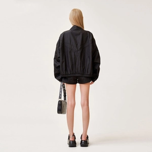 Rear view of black viper skin texture jogging shorts and athletic set on model