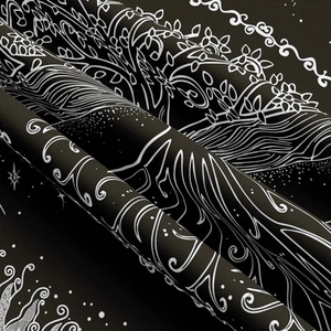 Detailed macro view of black bohemian tapestry showing fine fabric texture and white tree patterns