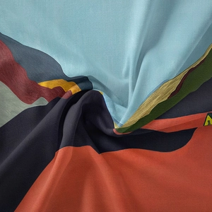 Macro shot of colorful Bohemian tapestry fabric with vibrant abstract spiral patterns