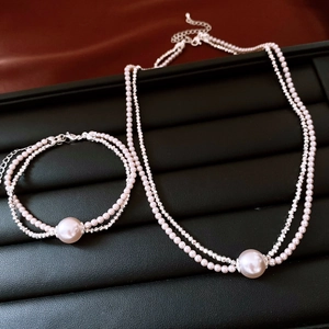 Detail of double-layer pink pearl and rhinestone necklace with adjustable silver chain