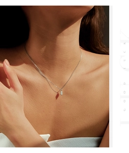 Macro detail of S925 silver marquise-cut solitaire diamond pendant on a collarbone chain
