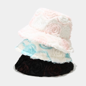 Macro detail of plush faux fur texture with 3D rose pattern on warm bucket hats