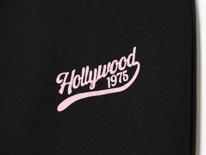 Detail of pink Hollywood 1975 text print on black long sleeve sweatshirt fabric