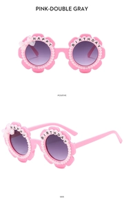 Detail of pink flower birthday sunglasses with pearls and Happy Birthday text on frame