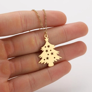 Detailed view of a gold Christmas tree pendant necklace with hollow star patterns