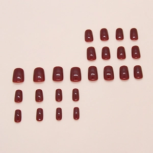 Glossy deep wine red short square press-on nails set with 24 pieces on pink background
