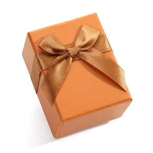 Elegant orange gift box with glossy finish and ribbon bow for jewelry and watches
