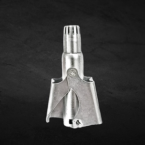 Detailed close-up of manual stainless steel nose hair trimmer on textured stone surface