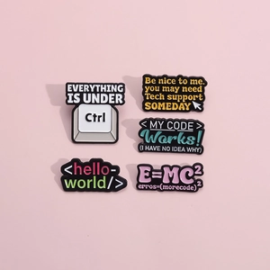Close-up of enamel pin set with funny programmer quotes like Everything is under Ctrl