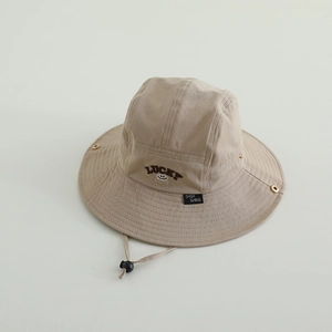 Detail of light beige sun hat with LUCKY embroidery and adjustable chin strap cord